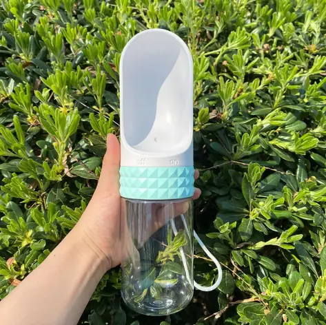 Small 320ml WanderPaws bottle in Sky Blue held up outdoors.