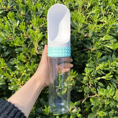 Large 520ml WanderPaws bottle in Sky Blue held up outdoors.