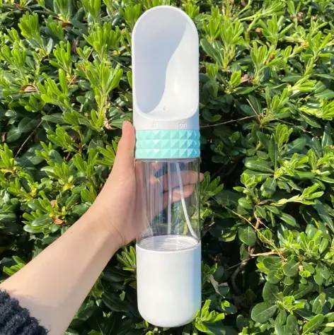 combo WanderPaws bottle in Sky Blue held up outdoors.
